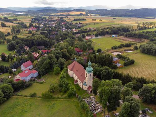 an aerial view of a small village with a church at Domek w górach 2 in Lubawka