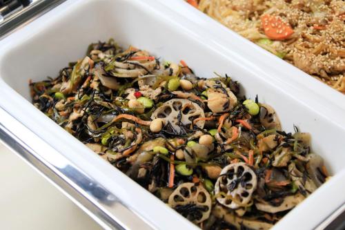 a white dish of food with mushrooms and other foods at Richmond Hotel Narita in Narita