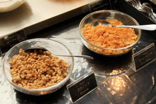 two bowls of food sitting on a counter with food at Richmond Hotel Narita in Narita