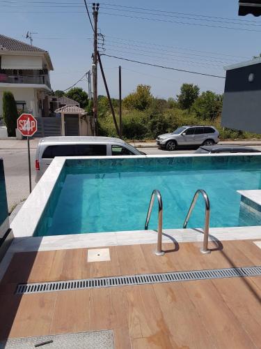 a swimming pool with two metal rails in it at Blue Star #4 in Paralia Katerinis