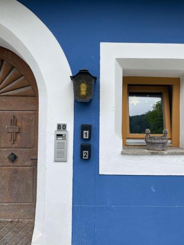 a blue building with a door and a window at Blue House in Ramingstein