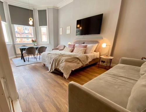 1 dormitorio con 1 cama y 1 mesa con sillas en Studio for 3 near Regents Park n5, en Londres