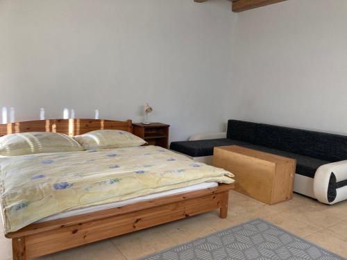 a bedroom with a bed and a couch at Na Mlejně in Telč