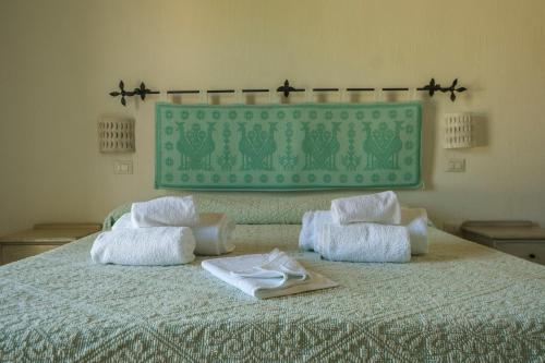 a bed with towels on top of it at B&B Terra e Smeralda in Arzachena