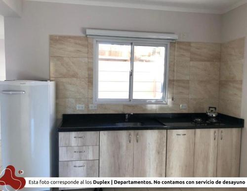 a kitchen with a sink and a window at Z Hotel Boutique in Puerto Iguazú