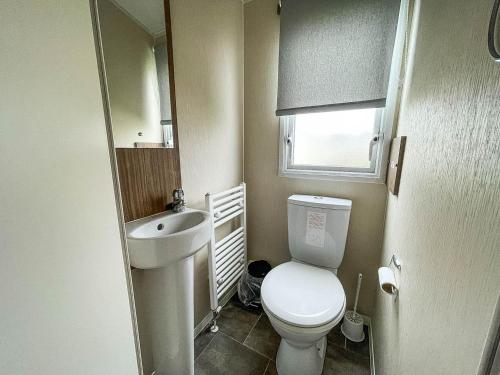 a small bathroom with a toilet and a sink at Superb 8 Berth Caravan For Hire At A Great Holiday Park In Norfolk Ref 50007a in Great Yarmouth