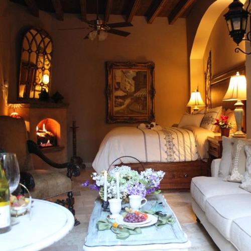 a living room with a bed and a table with flowers at Luxury Villa Retreat - 8 Bedrooms - Sleeps 20 in San Miguel de Allende