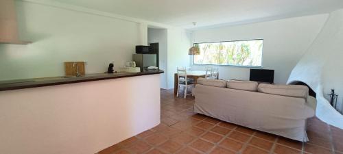 a living room with a couch and a table at Casas da Barra in Praia de Mira