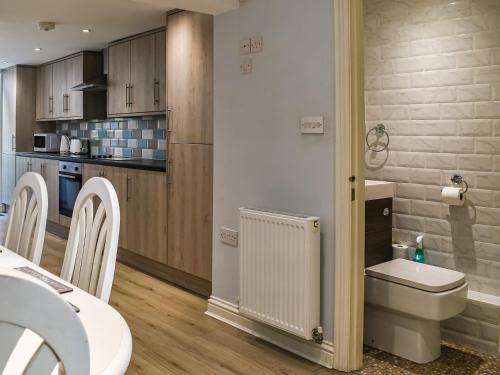 a small kitchen with a toilet and a sink at The Beach House in Ramsgate