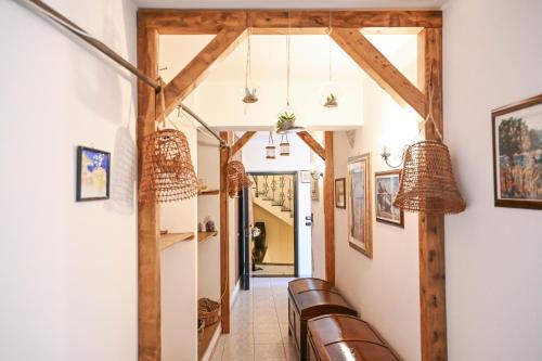 a hallway with wooden beams and chairs in a house at Il Porticciolo in Scilla