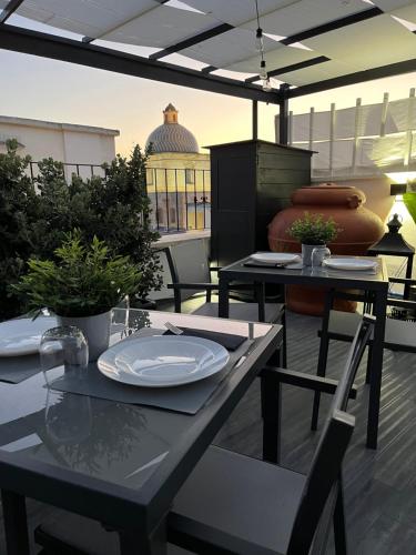 a table with plates on it on a patio at Terrazza Poesìa in Brindisi