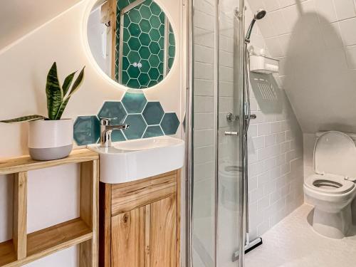 a bathroom with a sink and a shower at Hazel Nook in Trotton