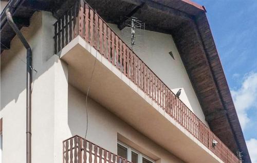a building with a fence on the side of it at 3 Bedroom Awesome Apartment In Klucze in Klucze
