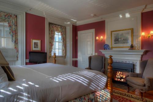 a bedroom with a large bed and a fireplace at Francis Malbone House in Newport