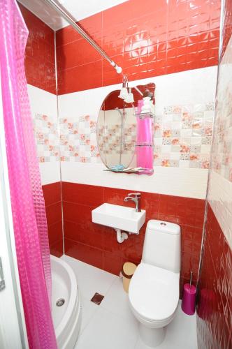 a bathroom with a toilet and a sink at Dzveli Batumi in Batumi