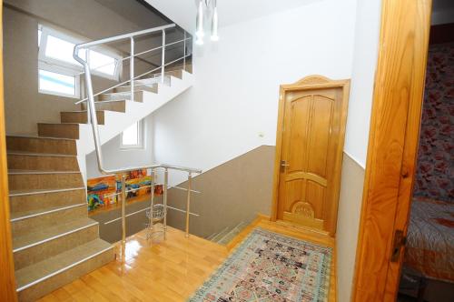 a room with a staircase and a door with a rug at Dzveli Batumi in Batumi