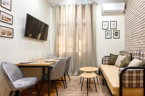 a living room with a table and a couch at ApartPro Apartments, Veliko Tarnovo in Veliko Tŭrnovo