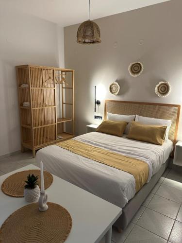 a bedroom with a large bed and a table at Electra Studios in Palaiochóra
