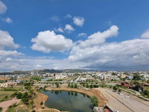 a city with a bridge over a body of water at Three Bed Attached Bath Netflix Wifi Smart TV Parking WFH Desk Near Airport in Islamabad