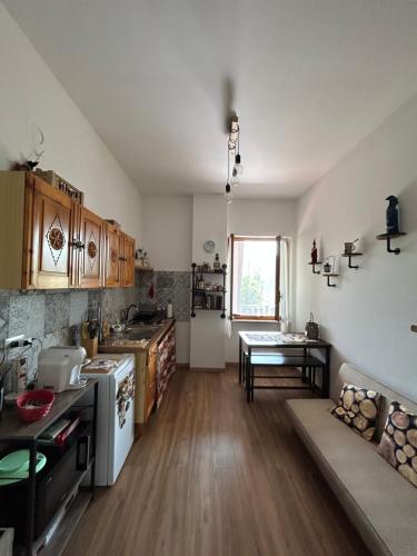 a kitchen with wooden floors and a table in it at Borgo Carletto Roburent - Immersi nella natura in San Giacomo