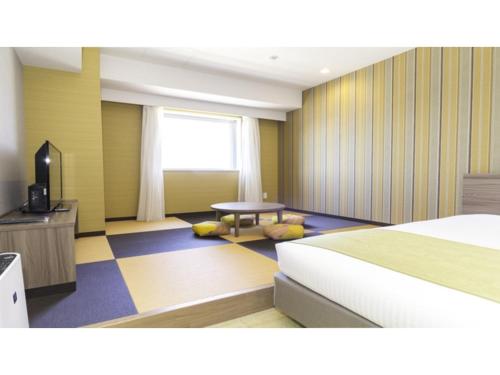 um quarto de hotel com uma cama e uma mesa em La'gent Stay Hakodate Ekimae - Vacation STAY 88790v em Hakodate