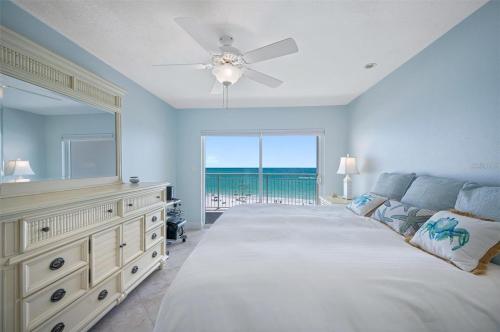 a large bedroom with a large bed and a large window at Oceanfront View of Madeira Beach, Steps to the Beach - Madeira Norte Condo in St Pete Beach