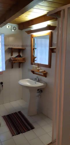 a bathroom with a sink and a window at Casetta con camino in La Magdeleine