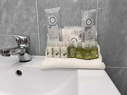 a bathroom sink with a towel and bottles of soap at Apartamento Casa Lola in Getxo