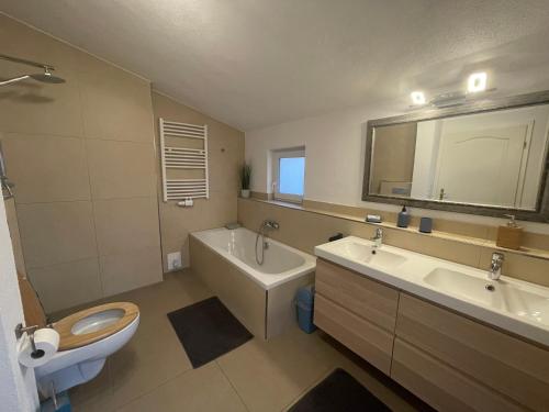 a bathroom with a toilet and a sink and a tub at #8 Doppelzimmer mit Gemeinschaftsbad in Memmingen
