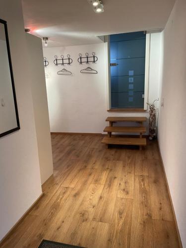 a room with a wooden floor and a large window at #8 Doppelzimmer mit Gemeinschaftsbad in Memmingen