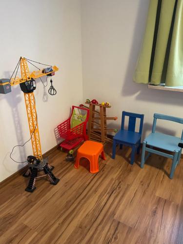 a room with chairs and a toy crane in it at #8 Doppelzimmer mit Gemeinschaftsbad in Memmingen