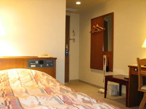 a bedroom with a bed and a desk and a desk at Hotel Fukui Castle - Vacation STAY 58682v in Fukui