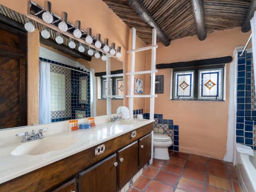 a bathroom with a large sink and a toilet at Bronce Del Sur in Santa Fe