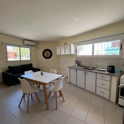 a kitchen and living room with a table and chairs at Dorrego Departamentos in Villa Dolores
