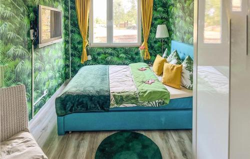 a bedroom with a bed with green wallpaper at Pet Friendly Home In Insko With Outdoor Swimming Pool in Ińsko