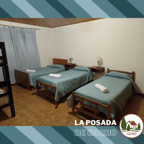 a room with two beds and two ottomans at La Posada De Cacho in San Rafael