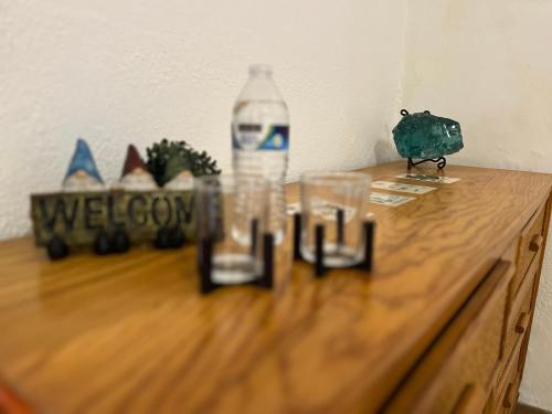 a bottle of water sitting on top of a wooden table at The stones house in the Historic Downtown in Querétaro