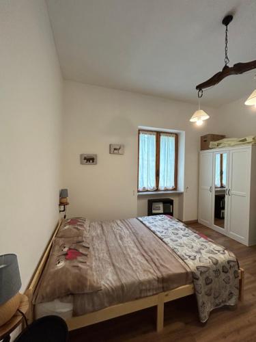 a bedroom with a large bed in a room at Borgo Carletto Roburent - Immersi nella natura in San Giacomo