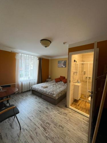 a bedroom with a bed and a shower in it at Godart Rooms Guesthouse in Tallinn