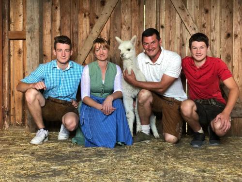 a group of people posing for a picture with a lamb at Bergbauernhof Stauder - Hirschbergalpakas in Lendorf