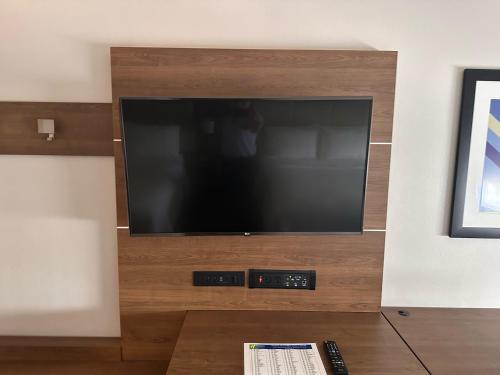 a large flat screen tv in a living room at Holiday Inn Express Hotel and Suites Mesquite by IHG in Mesquite