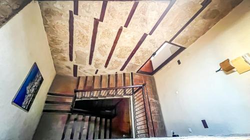a spiral staircase in a house with a ceiling at La Fonda de Xiva in Chiva de Morella