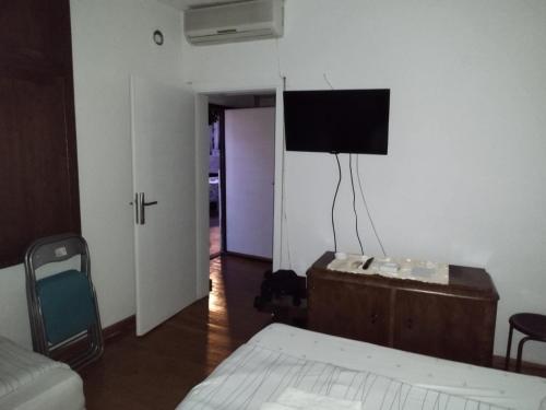 a bedroom with a bed and a tv on the wall at Bilyana Apartments in Ohrid