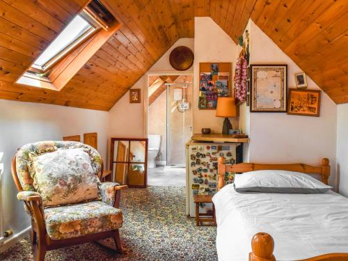 a bedroom with a bed and a chair at Court House in Halsall