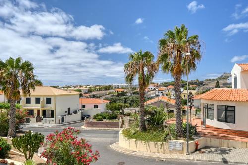 a view of a town with palm trees at Porto Santo Pip House, a Home in Madeira in Porto Santo