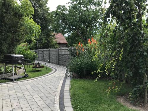 a walkway in a garden with a grill in a yard at Ranczo Popowice in Pątnów