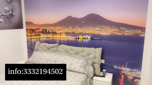 a bedroom with a bed with a view of a city at Dantonarooms in Naples