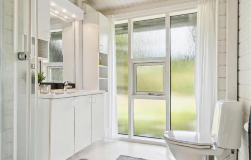 a bathroom with a toilet and a window at Lovely Home In Humble With Kitchen in Humble