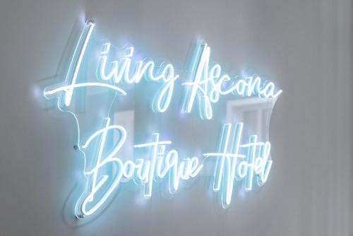 a neon sign that reads living heartbeat bubble theory at Living Ascona Boutique Hotel in Ascona