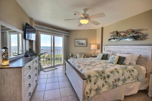 a bedroom with a bed with a ceiling fan and a window at 4409 Ocean Pointe in Tavernier